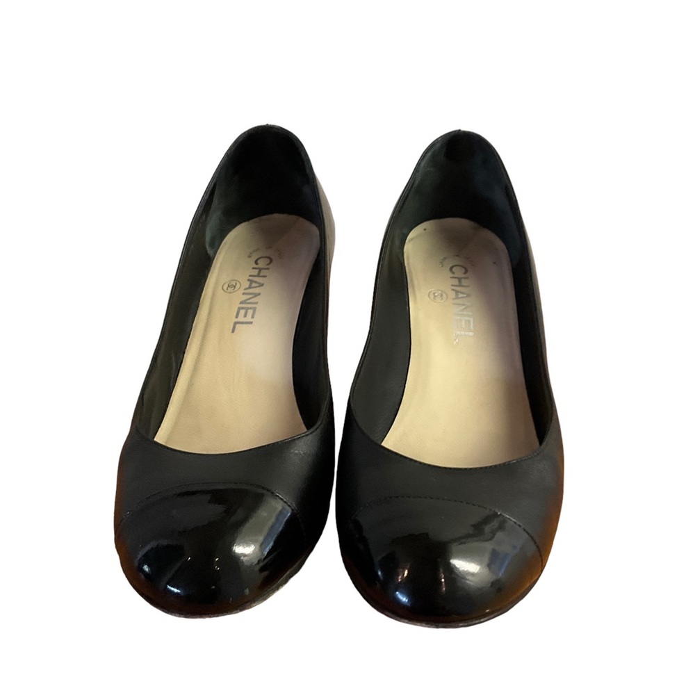 Chanel black wedge shoes with rounded toe.